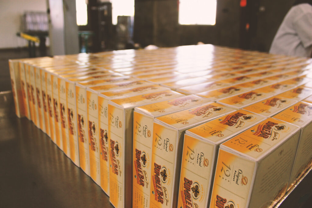 Rows of BumbleBar retail display boxes stacked and ready for shipping.