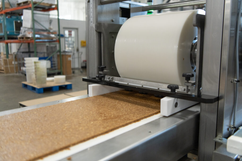 Dough sheet feeding through a roller pressing machine