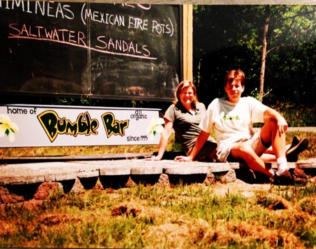 Glenn and Liz Ward beside the hand-painted Home of BumbleBar sign on Vashon Island in the late 1990s, where their food manufacturing story began