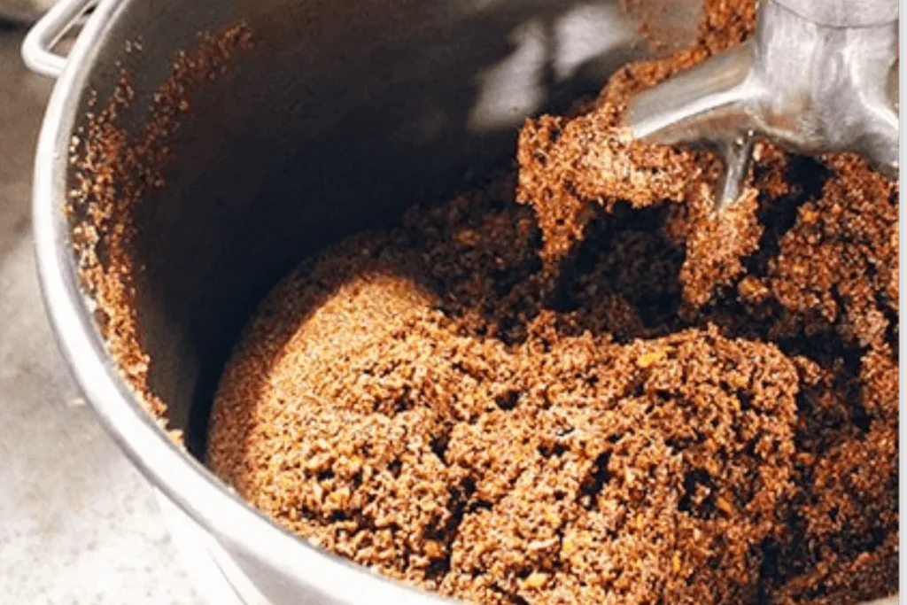 Bar mixture being blended in a large commercial mixer bowl.